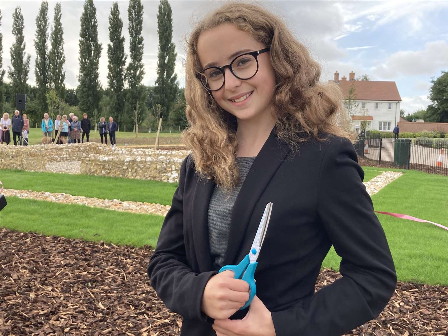 Ellie Wolfe, 12, cuts the ribbon to unveil the Romano-British temple uncovered outside her home in Newington near Sittingbourne. She attends Rainham Mark Grammar School