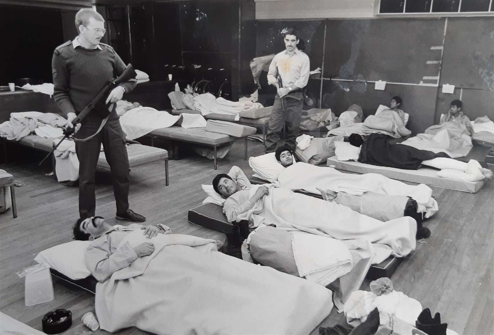 Brian Short, left, guarding Argentinian wounded prisoners in 1982. From his book The Band That Went to War