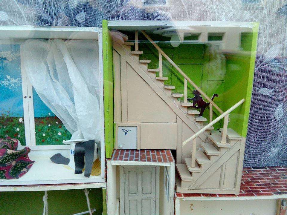 Stairs with a climbing cat and 'Harry Potter' cupboard created by Sheppey artist Richard Jeferies for his 24-room front window Advent calendar