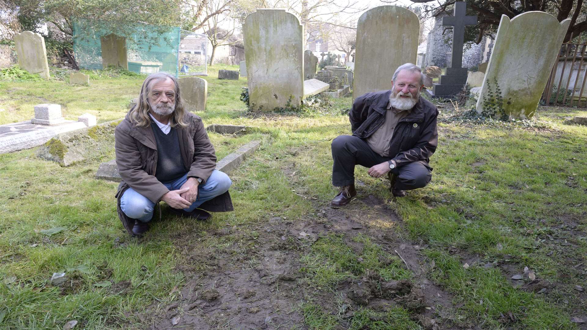 Ronald Taylor and Terry Wilson with the damaged turf in the graveyard at All Saints, Birchington.