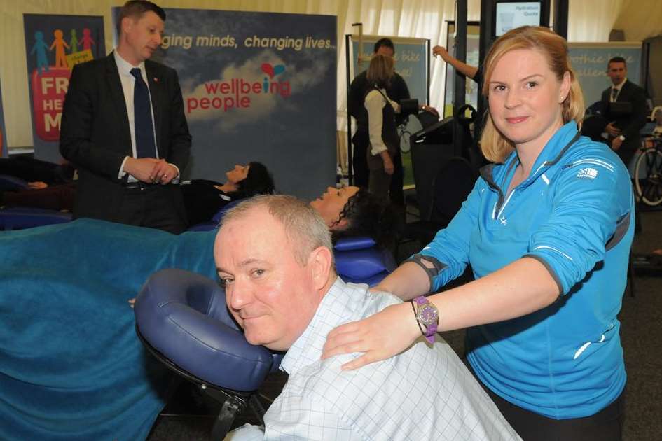 Rebecca Beardon gives Kev Hetherington a sports massage at the Wellbeing Symposium