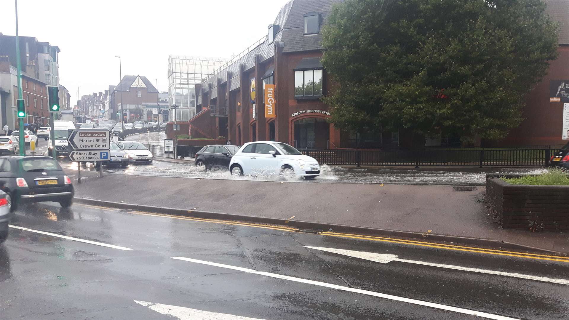 Cars drove through puddles of water by the gyratory