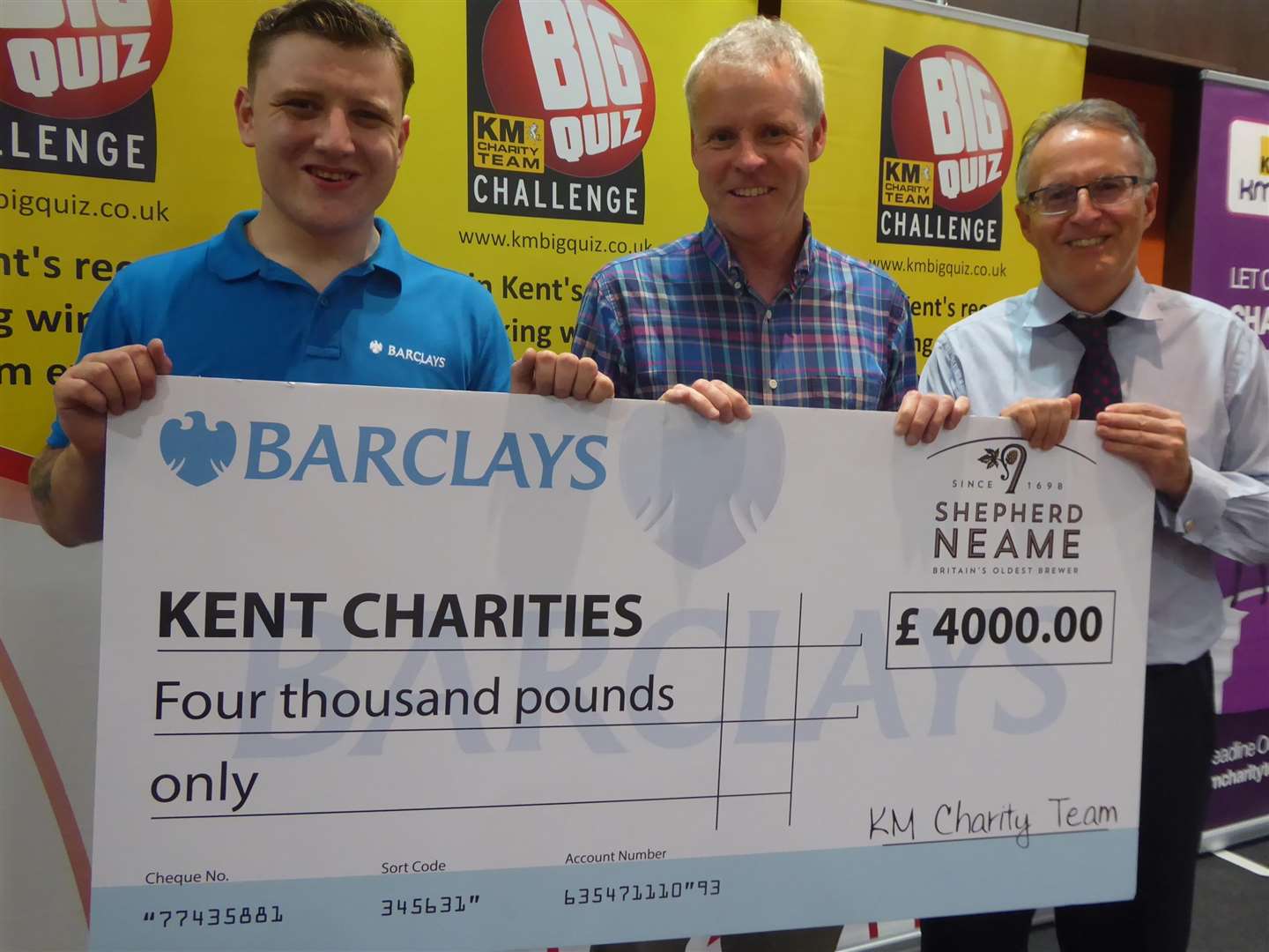 Anthony Wratten of Barclays joins David Fifield of Hallet and Co and Clive Perry of Specsavers to announce the figures raised at the Ashford KM Big Charity Quiz 2018 (2576200)