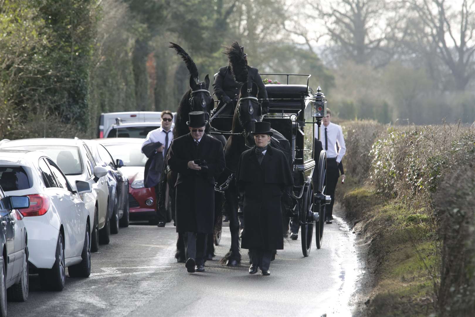 The procession was led by a horse drawn hearse