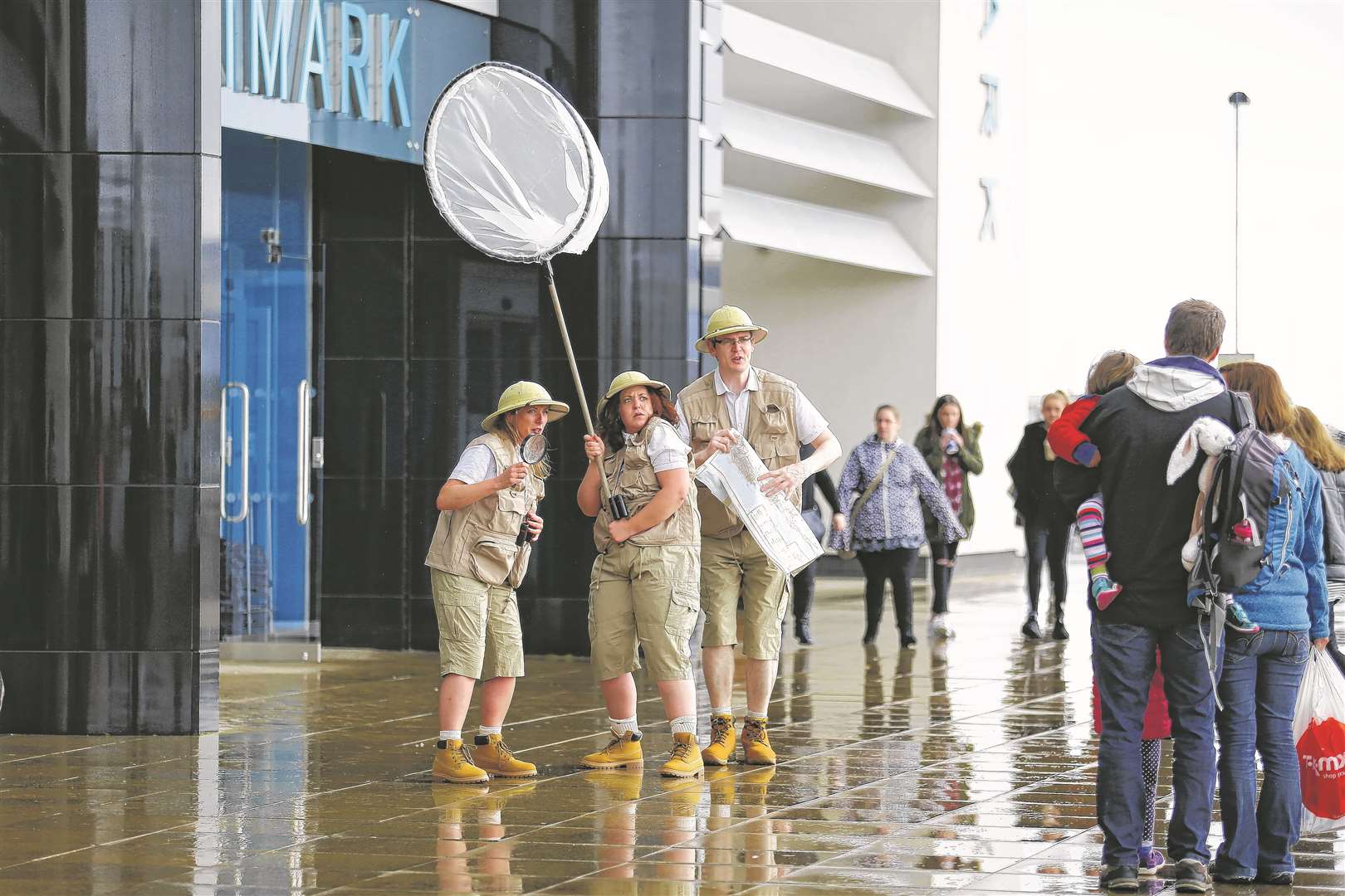 A team of eccentric explorers performing skits and engaging with shoppers