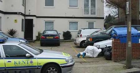 Police searching for clues outside the victim's flat. Picture: REBECCA FOOT