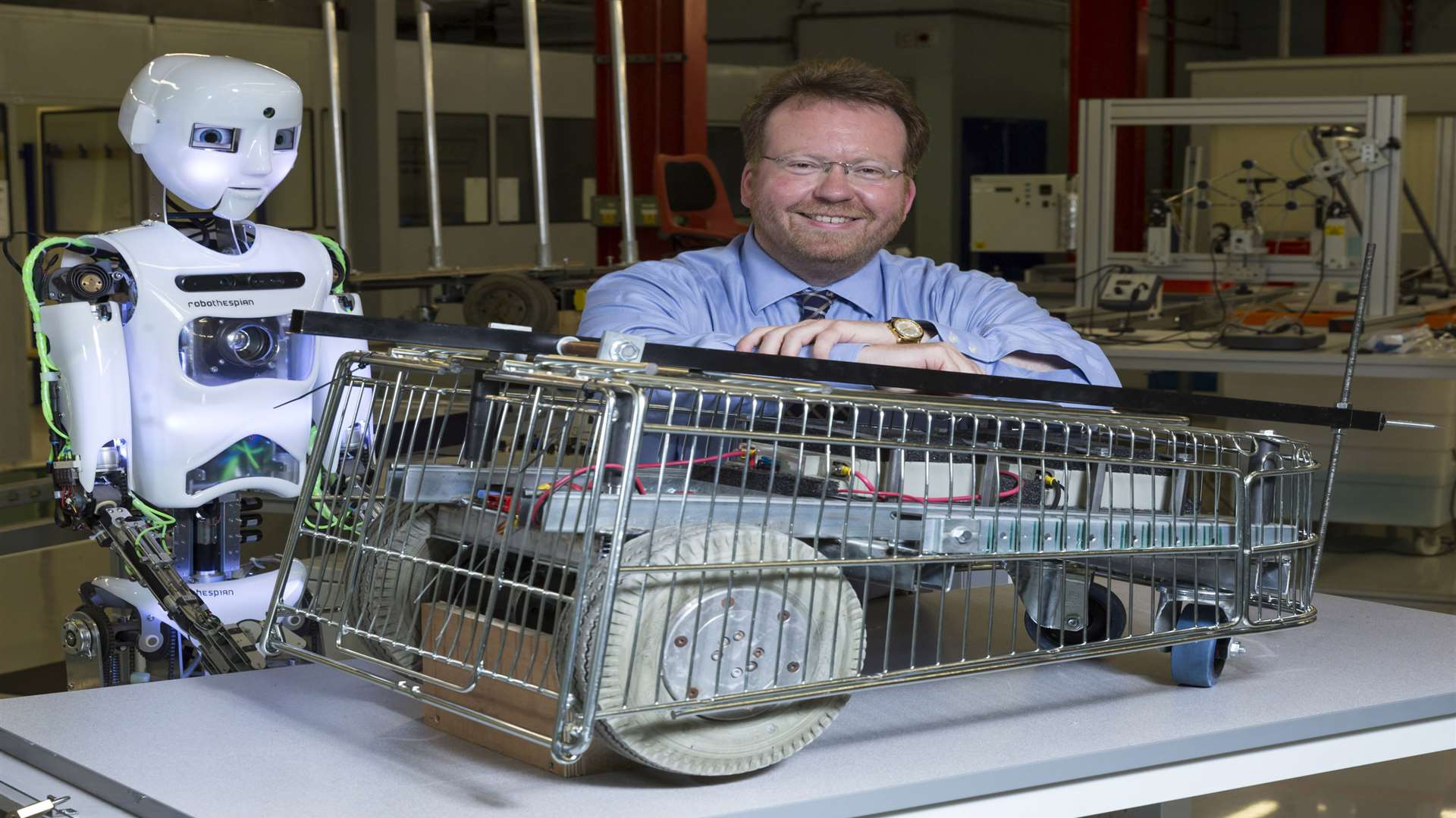 Prof Simeon Keates with Trolley Rage, the first robot the university built.