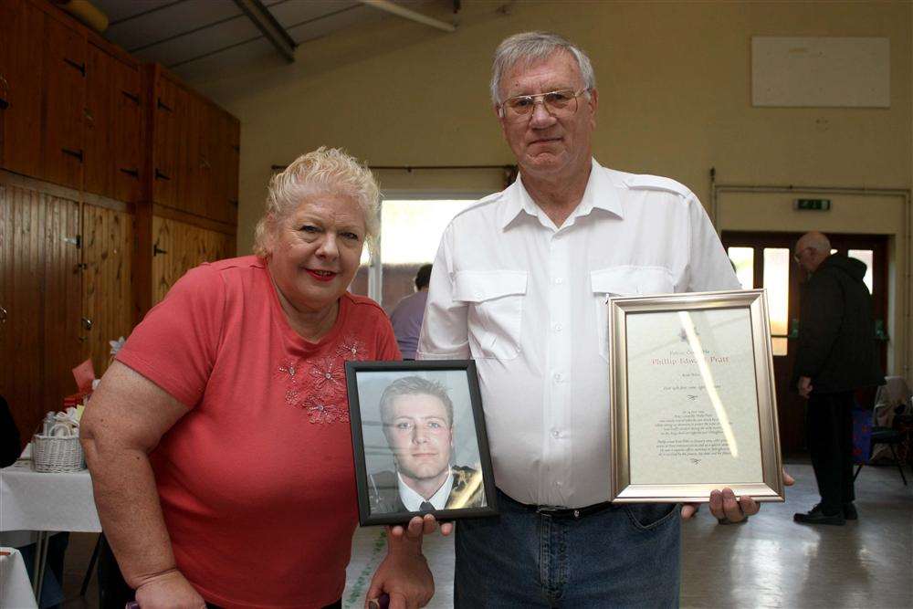 Christine and Ted Pratt, with a picture of their late son PC Phillip Pratt