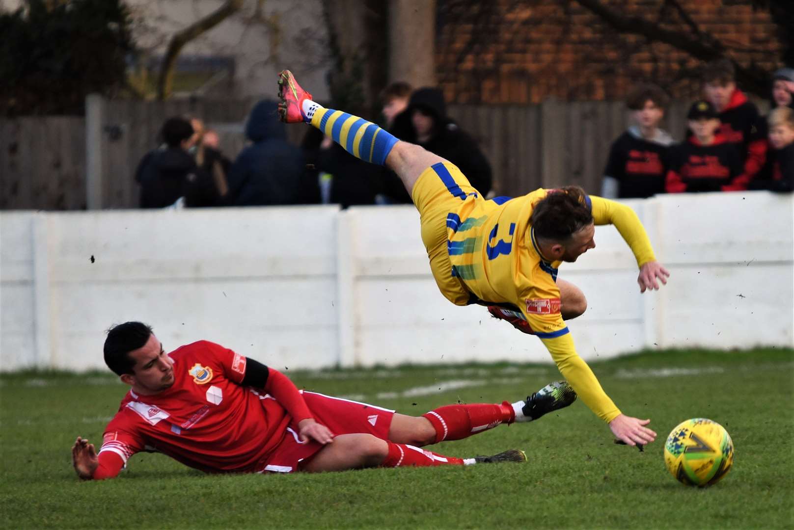 Taylor Fisher takes a tumble in Sittingbourne's win at Whitstable Picture: Ken Medwyn