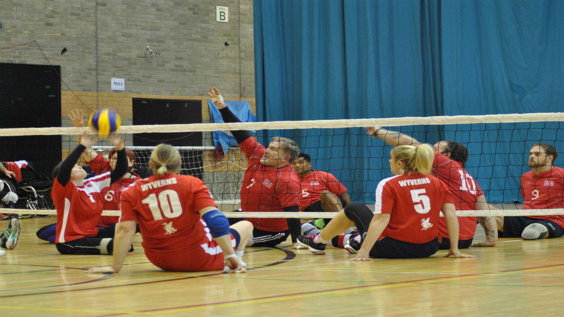 Darren Young, wearing the number 7 jersey, playing sitting volleyball