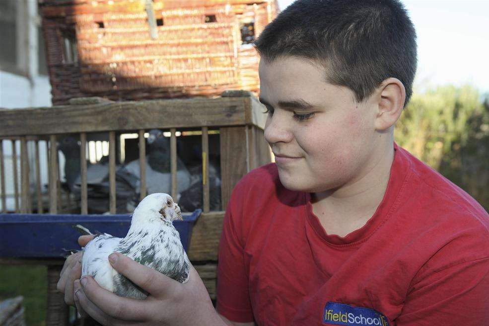 Reece Stone with one of his beloved racing pigeons