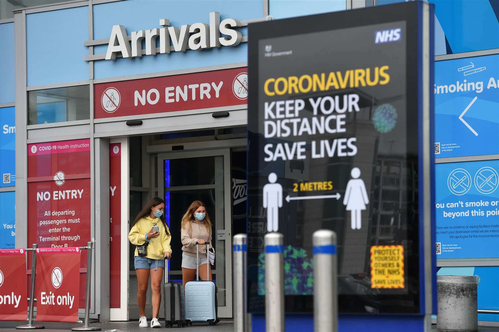 Passengers at Birmingham Airport, as people arriving into En…land from holidays in Spain have been told they must quarantine when they return home (Jacob King/PA)