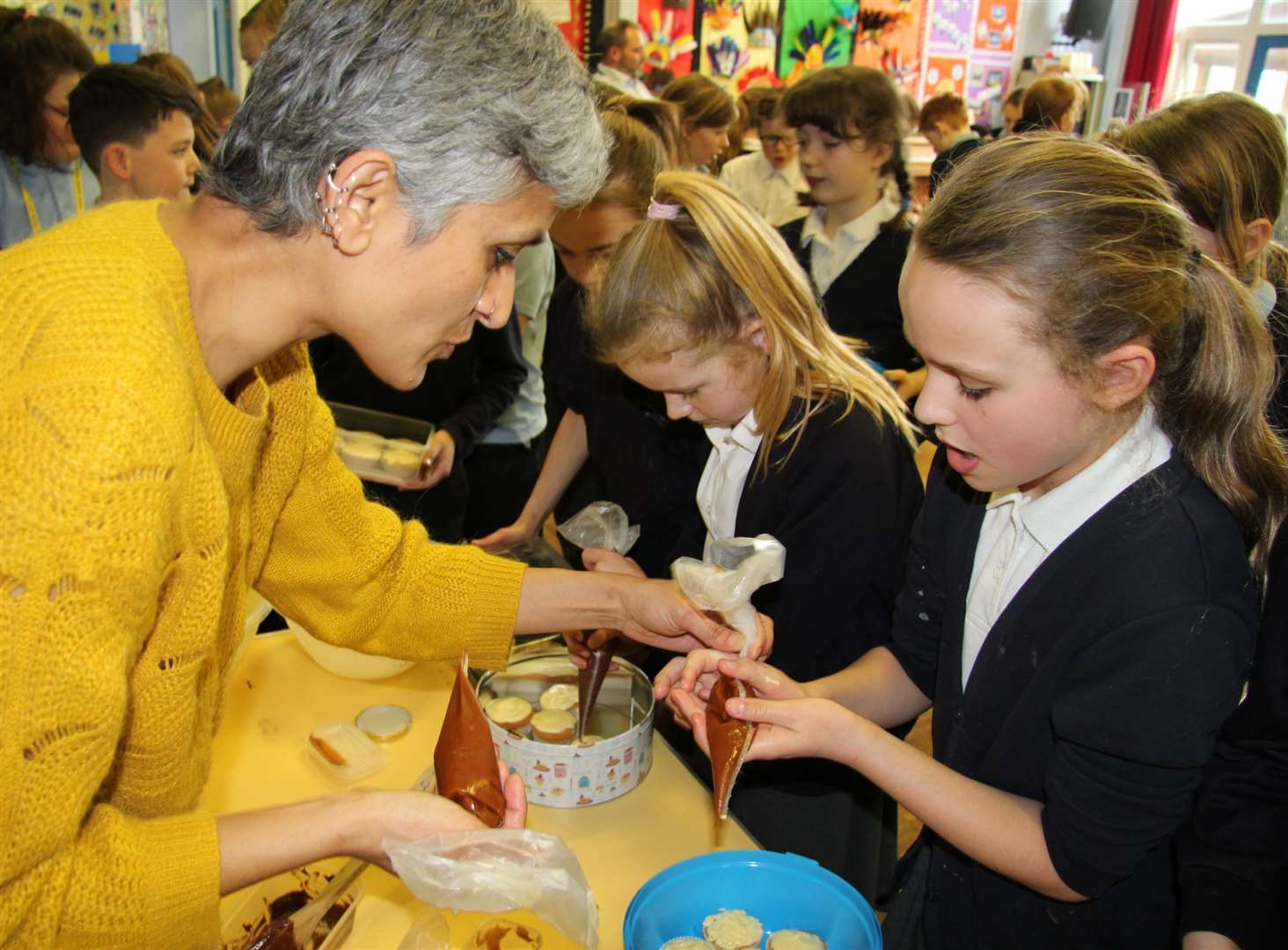 Chetna Makan helps Upton School pupils with their baking