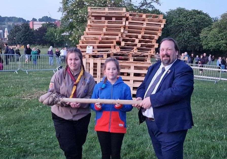 Cllr Vince Maple is with Lola and Emily, who helped with torch duties. Picture: Nikki Drury