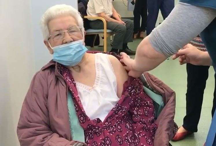 Winifred Prett receiving her jab - the first to be administered in the Canterbury district