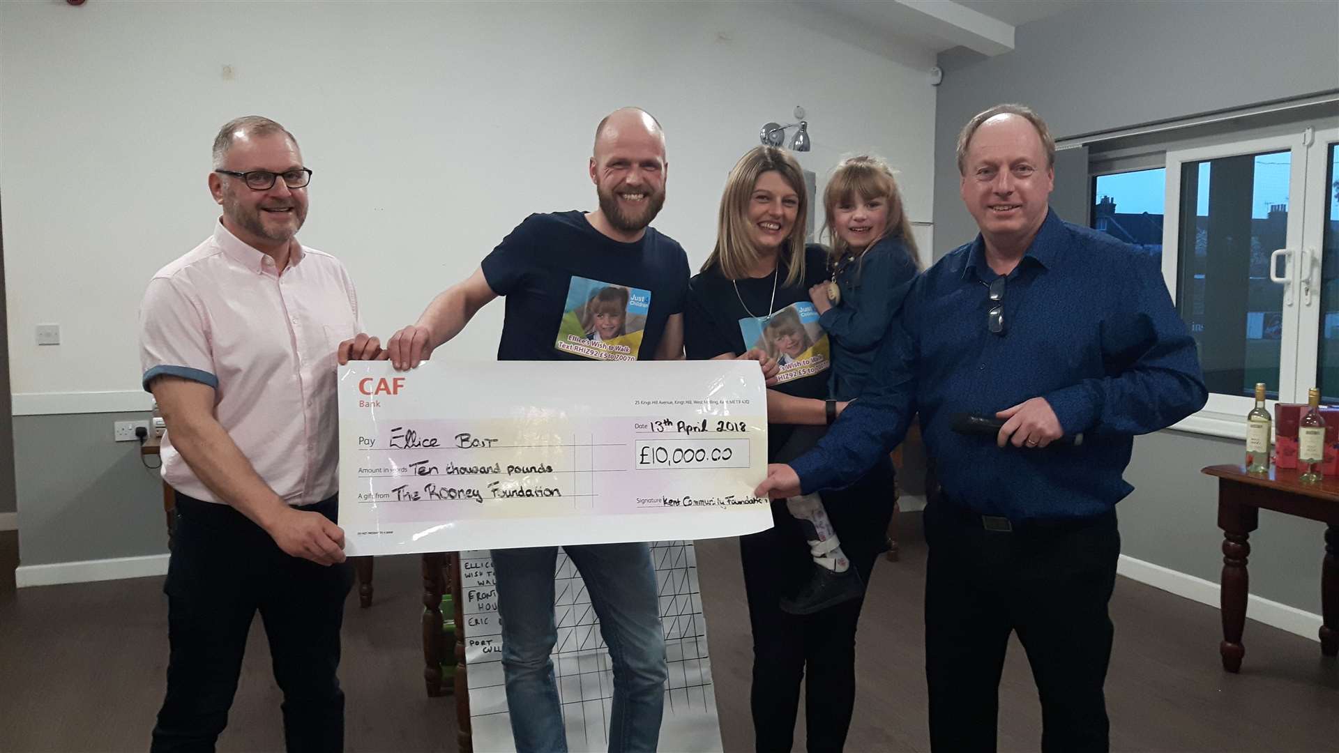 Robert Bagley MBE (left) and grant fundraiser Colin Smith MBE (right) present a cheque to Ellice Barr and her parents, Joe and Amy.