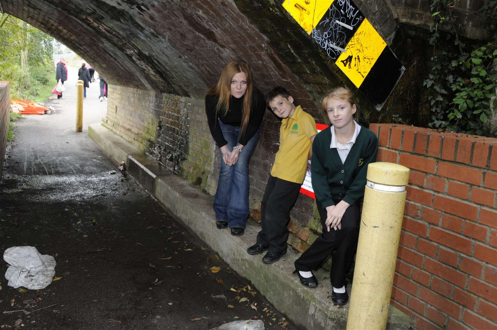 The height between the raised pavement and the rail bridge is highlighted by this nine- and five-year-old