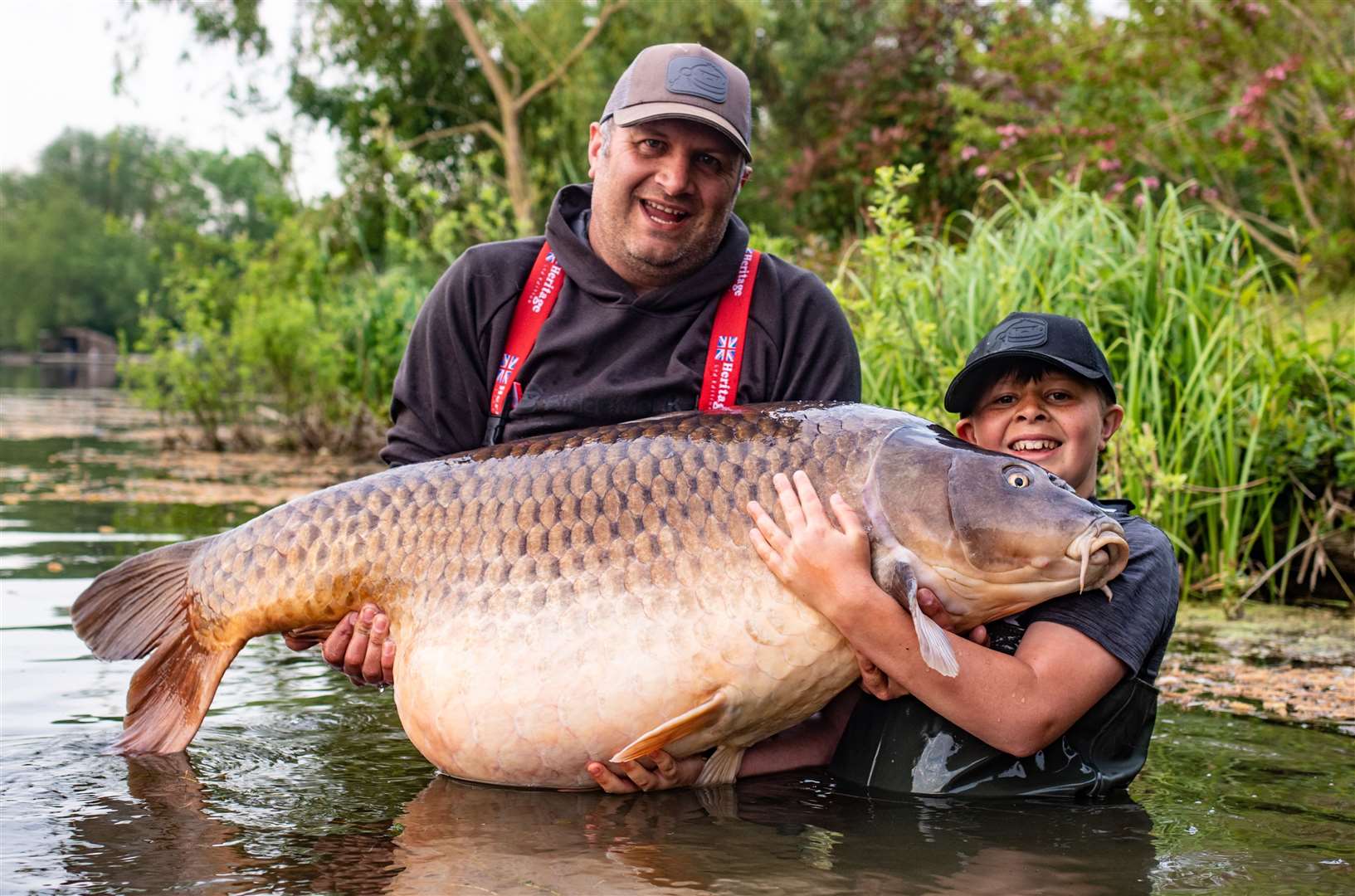 Callum Pettit, 11, pictured with dad Stuart, broke the world record for a common carp caught by a junior. Picture: Keith Pickett