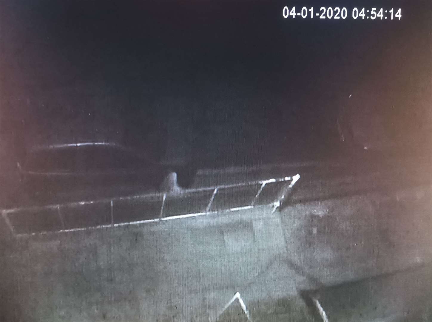 CCTV shows a blurred figure at the front wheel of a car in Northfleet on the night vandals slashed the tyres of multiple vehicles