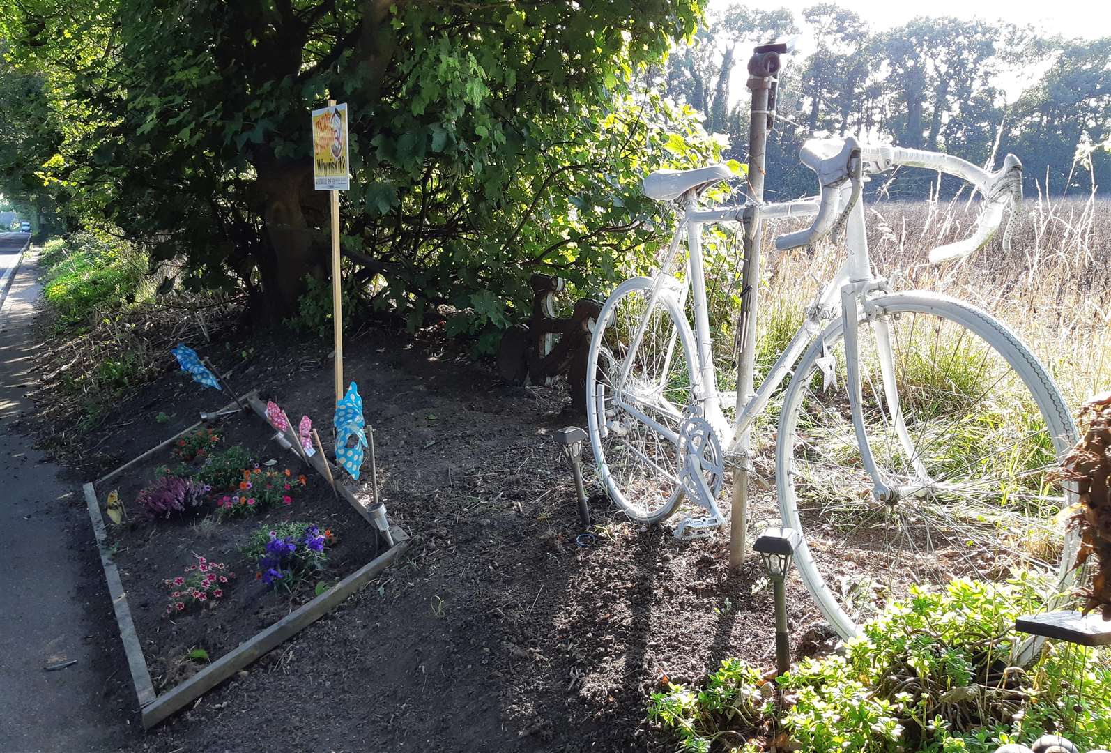 The ghost bike and flower beds are a reminder to drivers of the A258 Deal to Dover Road to watch out for cyclists