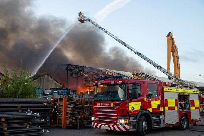 Firefighters tackle the blaze in a warehouse at Chatham Docks. Picture: KFRS