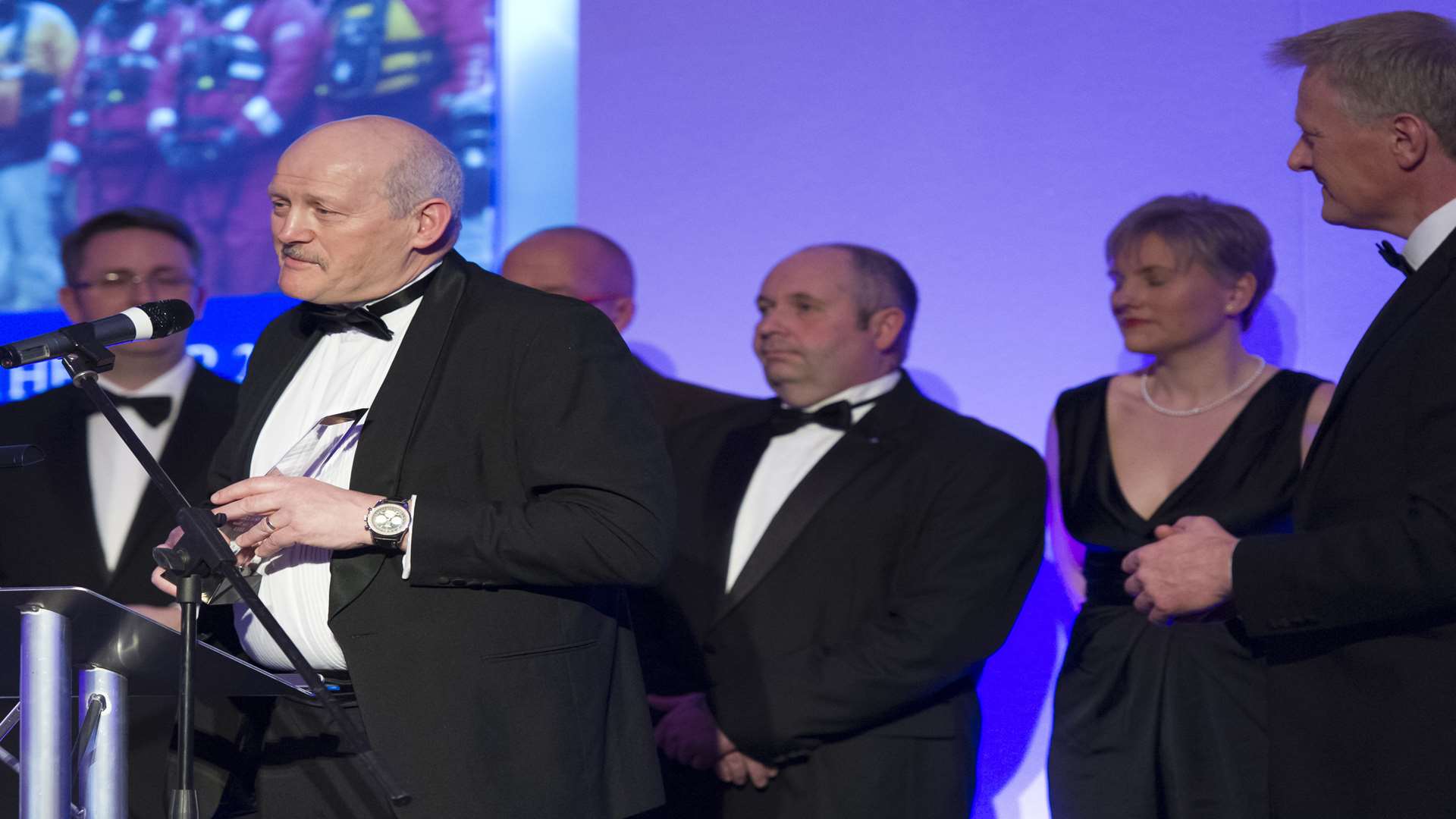 Paul Lewis, from overall winners 2015, Kent Search and Rescue, accepts the award on-stage