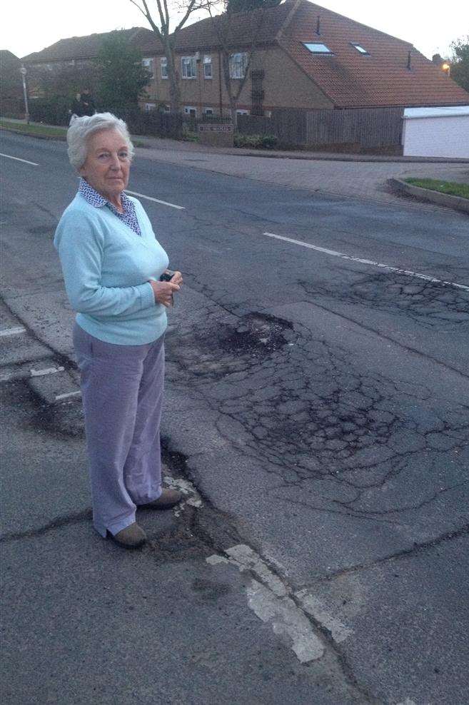 Joyce Covell, of The Broadway, Minster, showing the damage at the road's junction with Shurland Avenue