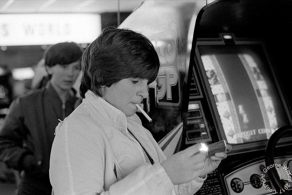 Lighting up at the arcade. Copyright: George Wilson
