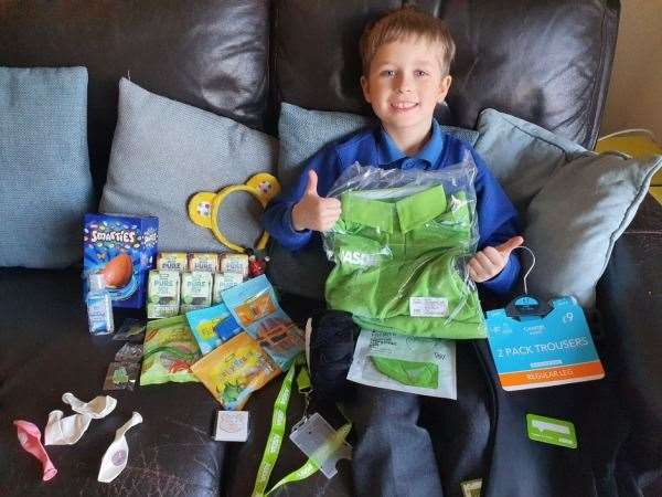 Luca with his uniform, an Easter Egg, sweets, balloons and other goodies sent from his local Asda store