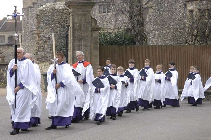 Members of the cathedral choir make their way into the service. Picture: Chris Davey