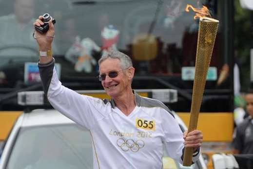 Ex-butcher Graham Cooper carries the Olympic torch through Seabrook