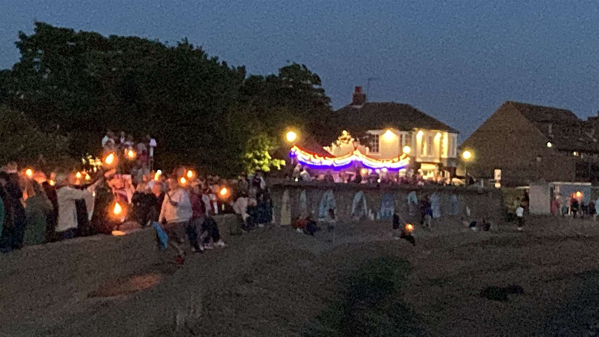 Crowds with torches at Queenborough to watch the lighting of Sheppey's only Platinum Jubilee beacon. Picture: John Nurden