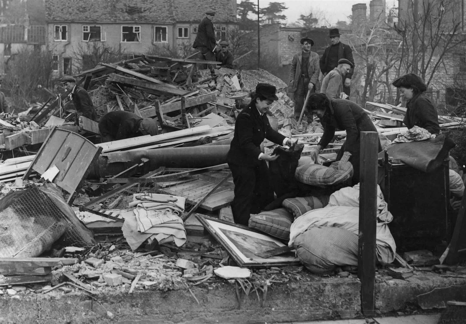 Salvaging bedding from a wrecked house after a shell fell in Portland Avenue, Gravesend on 13th November, 1944. This picture was censored not to be published at the time. Copyright KMG (21437074)