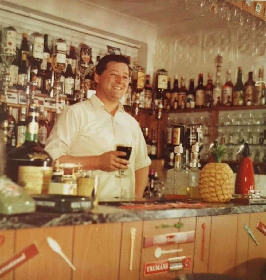 Clarence with a pint at his bar