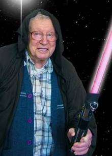 Alf Nicholls, a resident of Abbeyfield Kent Society, with his Star Wars lightsaber
