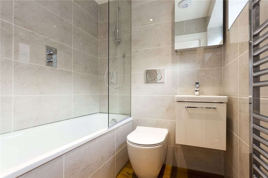 The bathroom features a bath and shower