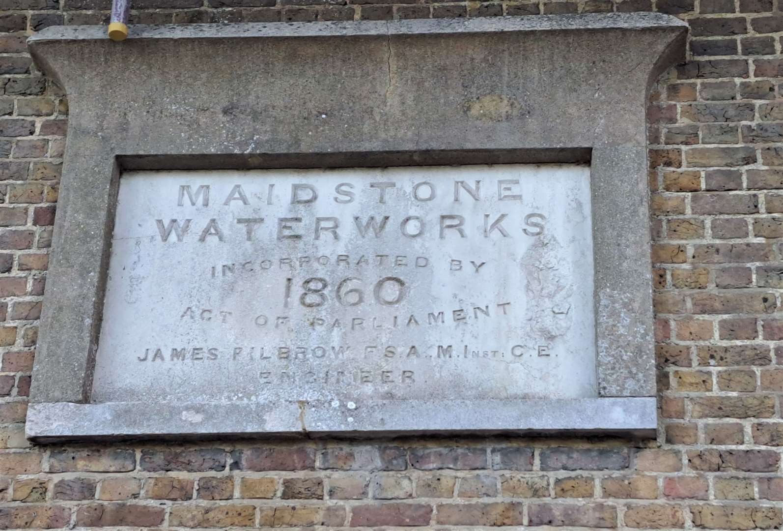 A commemorative plaque on the side of The Works