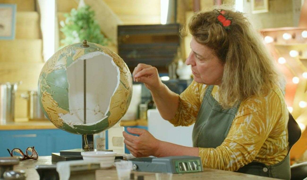 Lucia Scalisi cleans Klare Kennett's globe on The Repair Shop. Picture: Ricochet/BBC