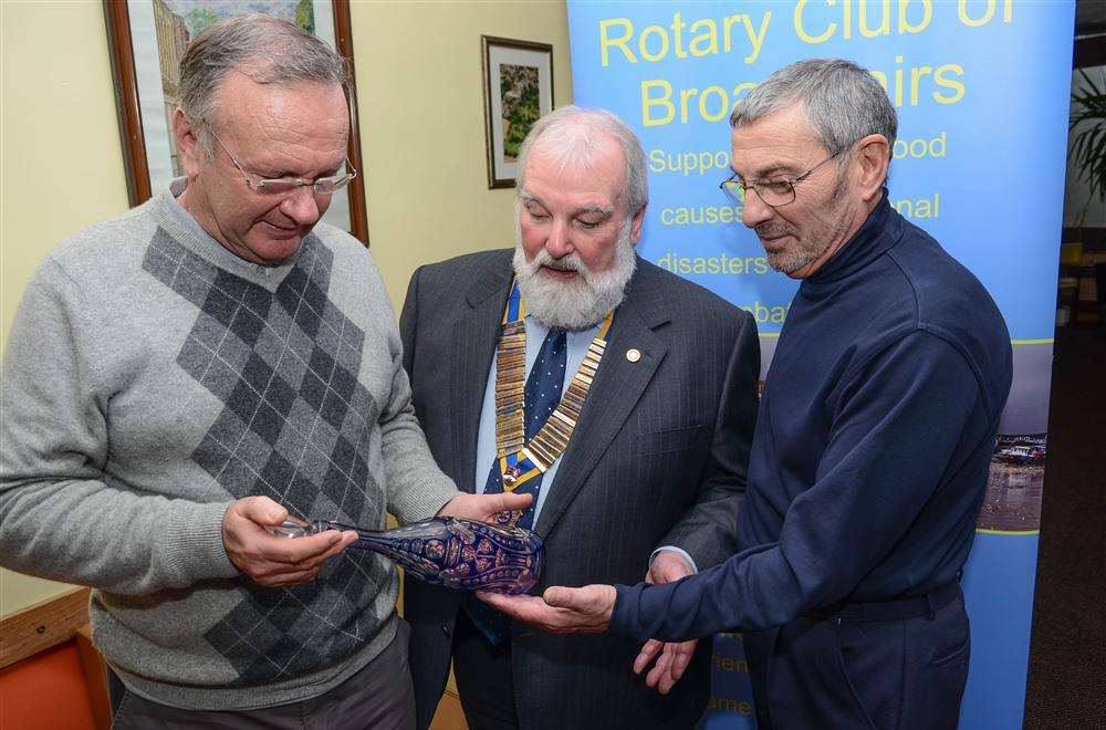 Broadstairs Rotary Club members Brian Short, Michael Dicks and Albert Smith assess an antique decanter.