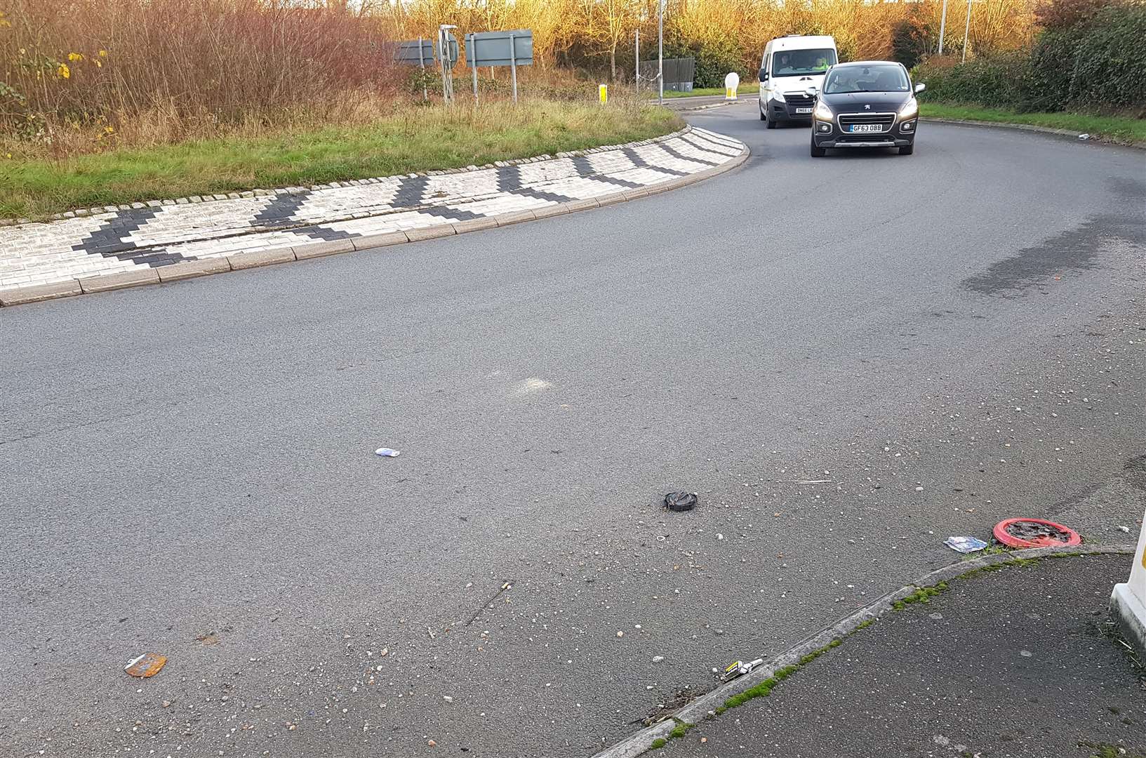 Some litter and debris is left on the carriageway