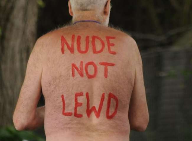 A rider on last year's naked bike ride gives a message to critics