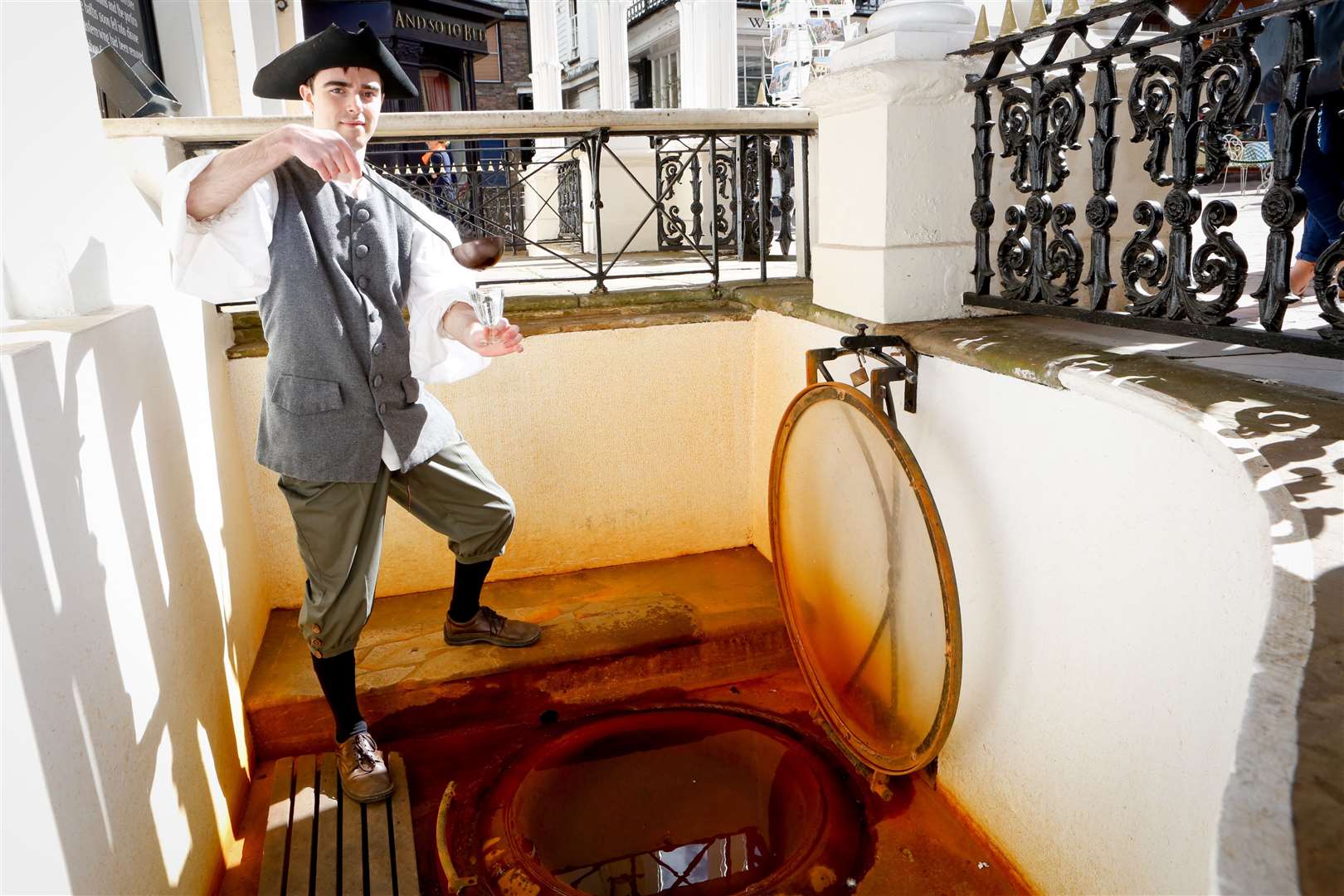Larry dips for water at the Chalybeate Spring on The Pantiles. Picture: Matthew Walker