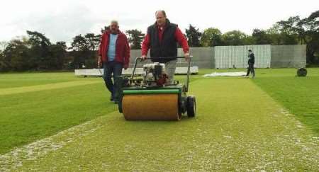 Groundsmen try in vain to mop up the wicket at Reading. Picture: ADY KERRY