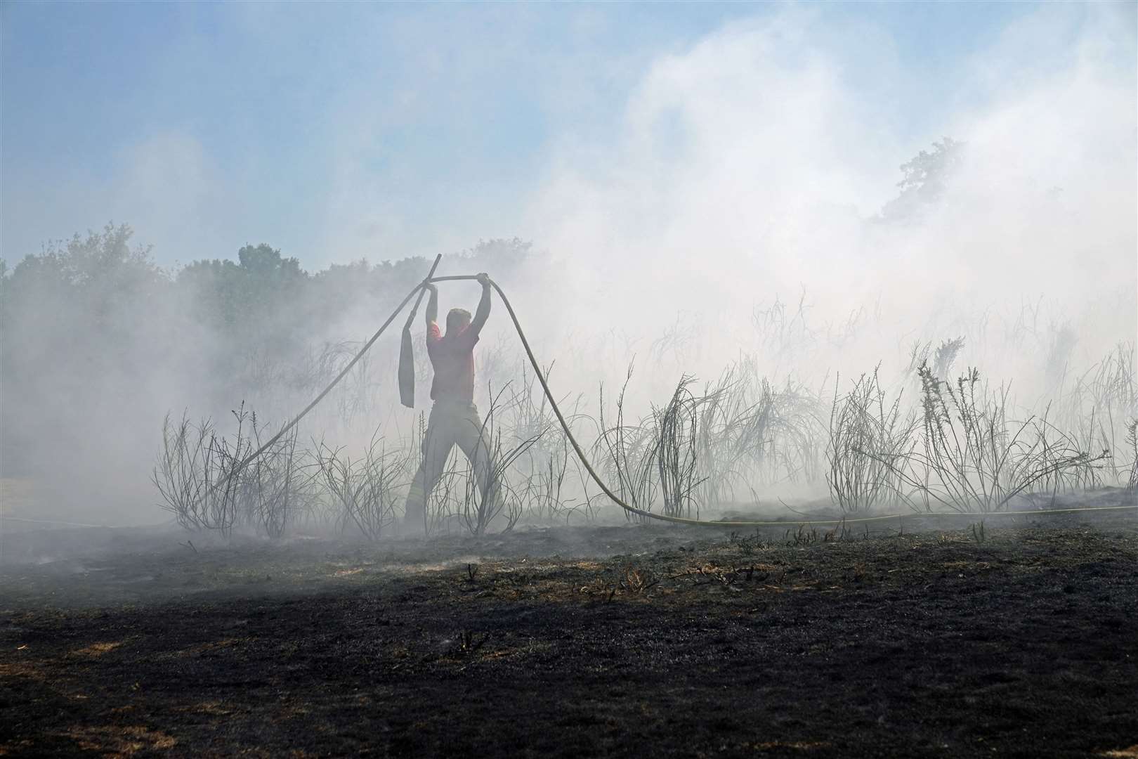 Firefighters battle a grass fire on Leyton flats in east London, as a drought has been declared for parts of England following the driest summer for 50 years (Yui Mok/PA).