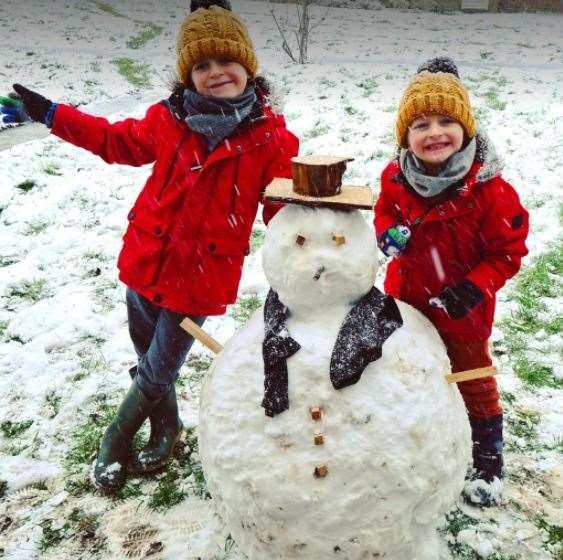 Albie and Joseph Wright make a snowman