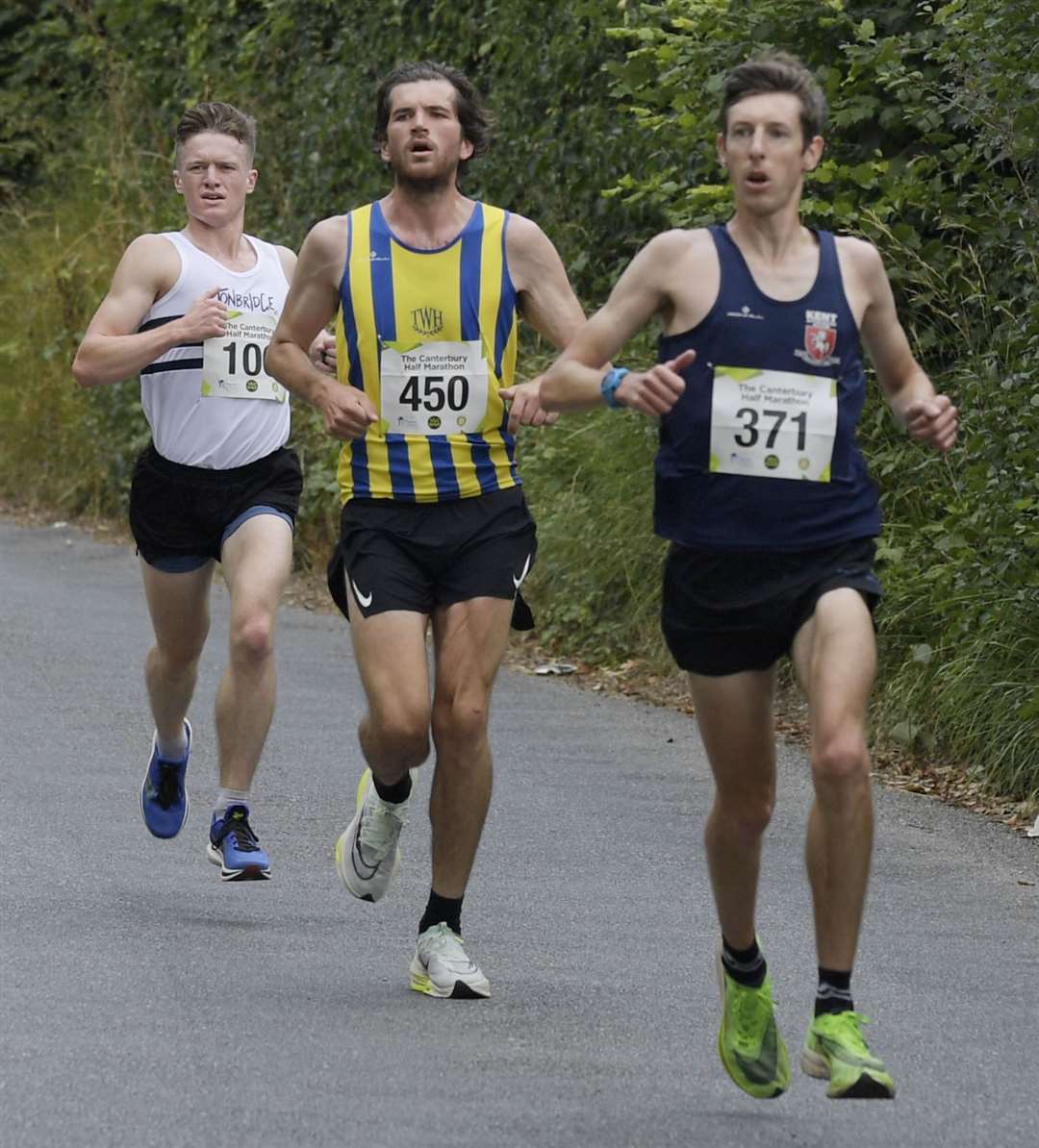 Canterbury Half-Marathon race winner Liam White (No.450) battles with fourth-place finisher Joe Hartley (371) and third-place George Marshall (No.106). Picture: Barry Goodwin