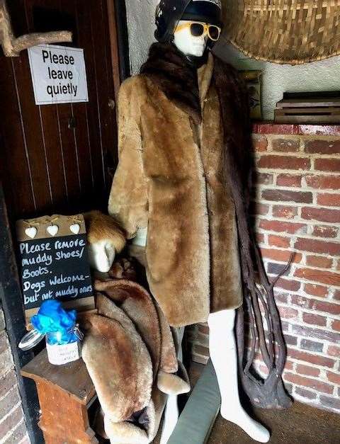 The copper in yellow sunglasses and a fur coat is there to greet you in the pub’s porch