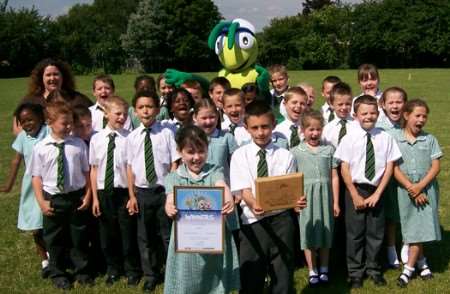 The Walking Bug presents the KM Green Footsteps Trophy to Class 3N of Riverview Junior School, Gravesend. The class won the award for the highest number of walkers for the Gravesham district with 26 out of 26 children walking to school on KM Challenge Day.