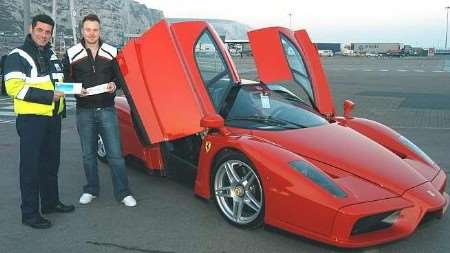 Paul Mitchell, left, from P&O Ferries takes a close-up look at the Ferrari Enzo with driver Nick Trott before the car boarded the ferry for France