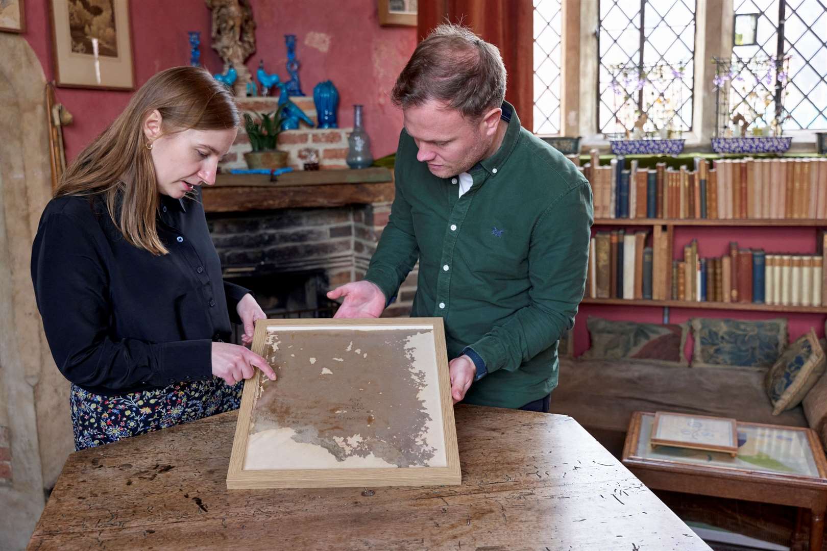 House and collections manager Eleanor Black and building surveyor James Kenton inspect a wallpaper fragment from Vita's Writing Room. Picture: National Trust Images/Arnhel de Serra
